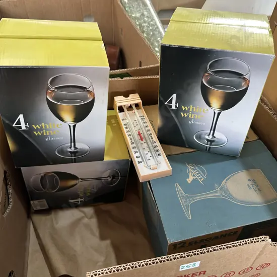 Four boxed sets of wine glasses plus a thermometer.
