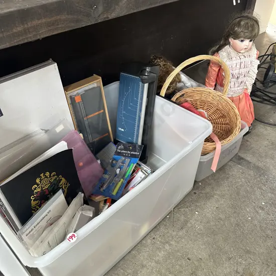 Dolls and lidded bin of  new stationary items including canvases.