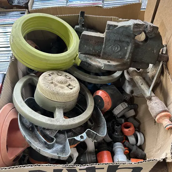 Box of garden sprinklers and fittings plus vice.