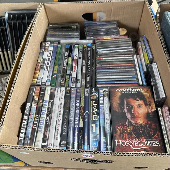 Box of DVDs and CDs and holder.