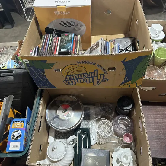 Two boxes pudding steamer, fan heater, CDs, clock/radio/alarm etc.