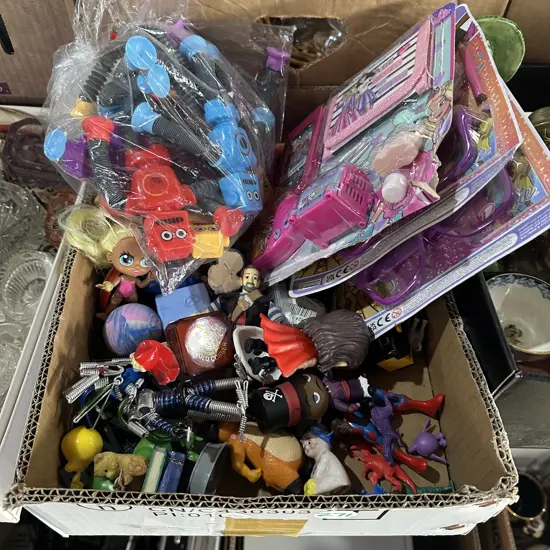 Box of toys including Barbie accessories sets.