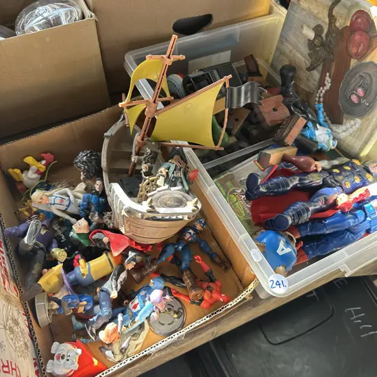 Two boxes of toy figures and vintage rubber stamps.