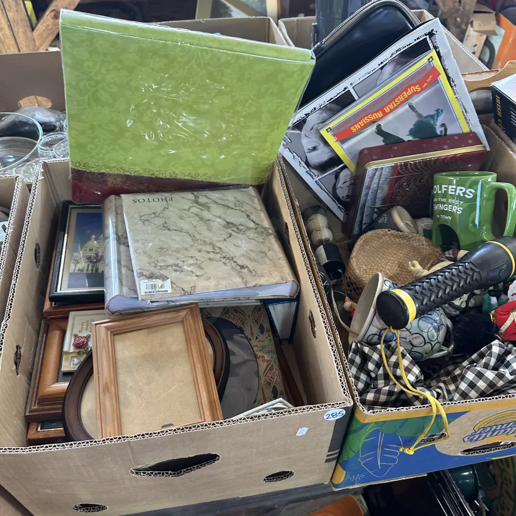 Two boxes with lots of picture frames, golf balls and pottery bell etc. Image 1++
