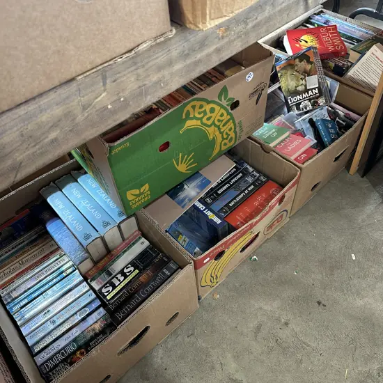 Five boxes of books, videos, cassettes, DVDs.