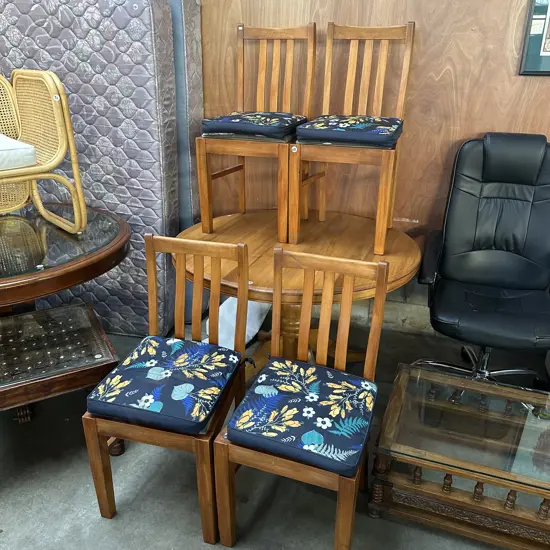 set of 4 Rimu dining chairs with cushions tied over worn seats