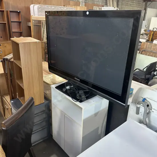 Large Panasonic TV on rolling cabinet