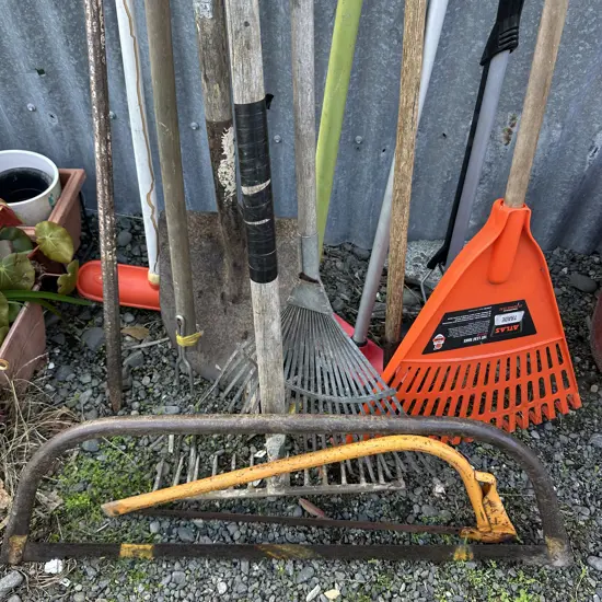 Garden tools, mop, broom and pinch bar.