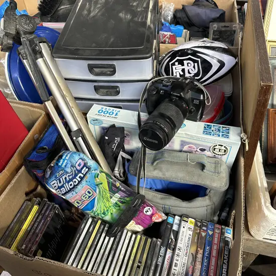 Two boxes camera and tripod, new puzzle, hobby drawers, good CDs and DVDs etc.