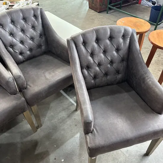 Pr of distressed leather button back chairs