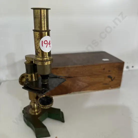Antique brass microscope including storage box. 20cm tall