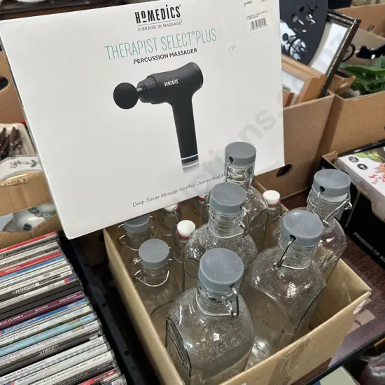 Boxed Homedics massager plus box of lidded bottles.