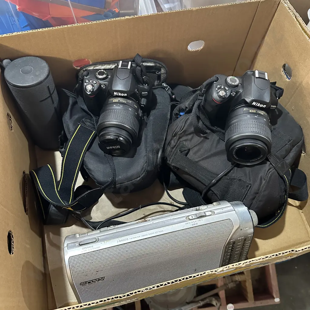 Two Nikon cameras and lenses plus carry bags, radio and Bluetooth speaker. Image 1++