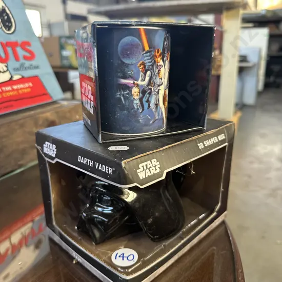Two boxed Star Wars collector mugs.
