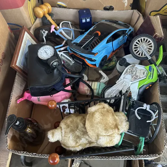 Box of toys etc plus a blood pressure sphygmomanometer.