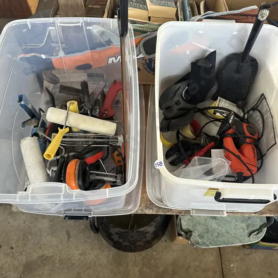 Two lidded bins of tools including a jig saw, saws etc.