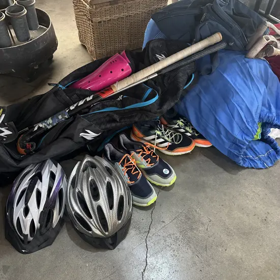 Hockey and golf gear with bag, bike helmets, shoes and bedding.