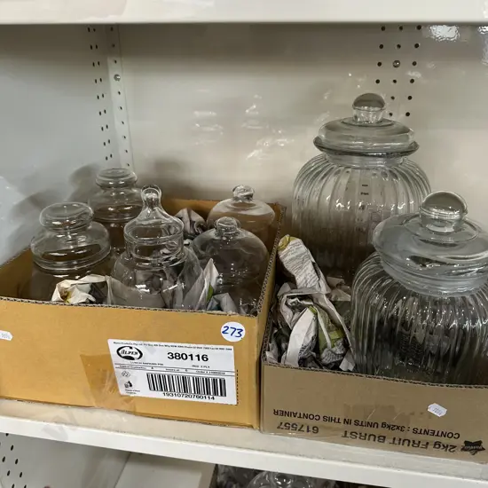 Shelf lot of glass lidded jars.