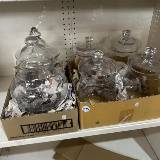 Two boxes of lidded glass jars.