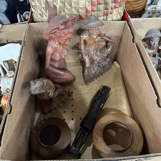 Box of carved figures and bowls.
