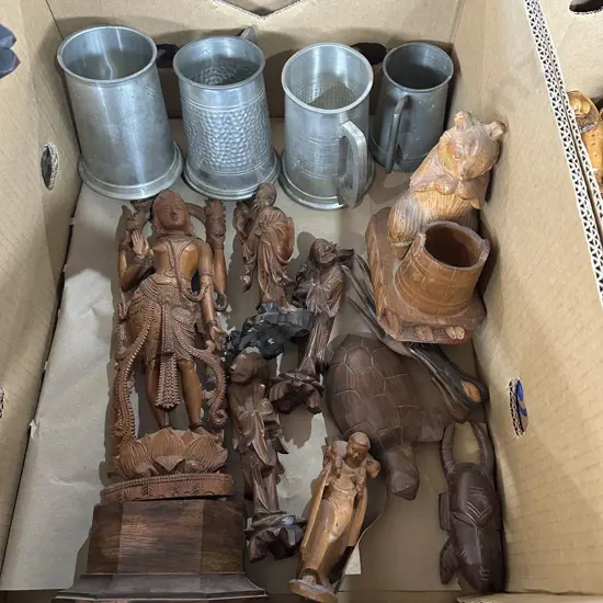 Box lot of carved figures and pewter cups.