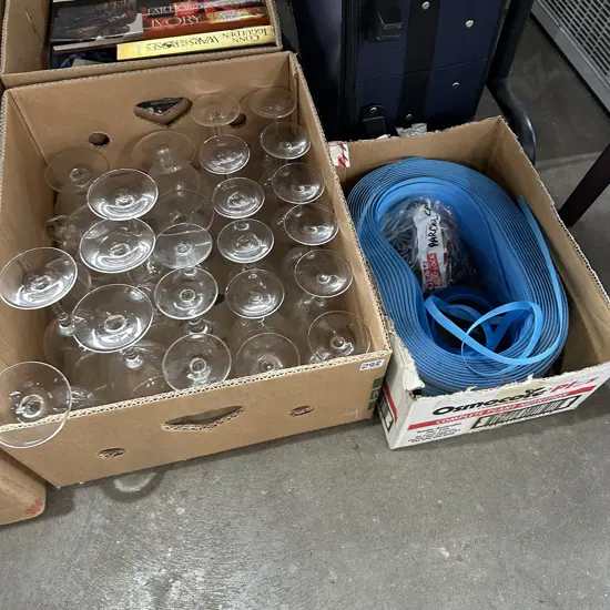 Box of glassware plus new blue plastic strapping and clips.