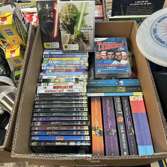 Box lot of DVDs and books including Star Wars and Thunderbirds.