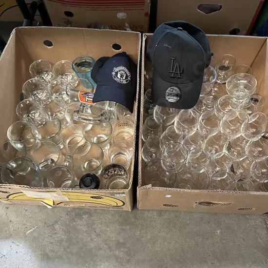 Two boxes of glassware and two caps.