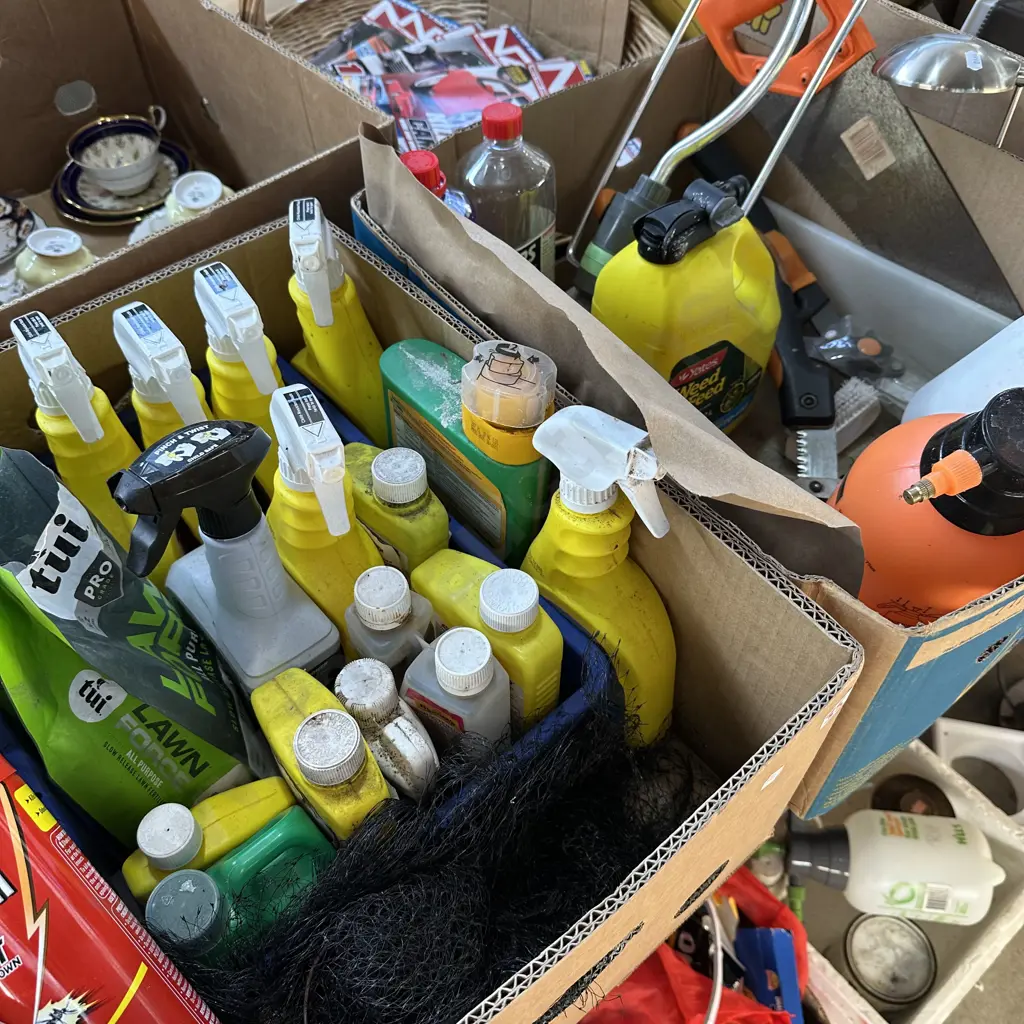 Two boxes of gardening sprays and fertilizers, tools and sprinkler plus fly spray. Image 1++