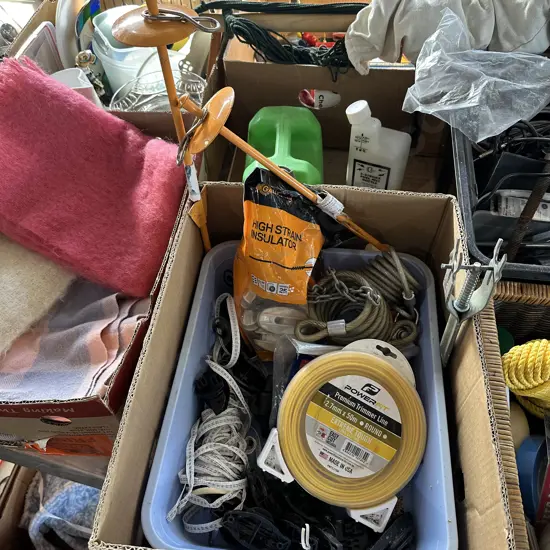 Box lot electric fence insulators, green petrol can, new trimmer line, bike locks etc.