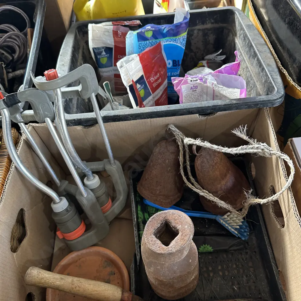 Bin of plant food and fertilizers plus a box of sprinklers, steel bells etc. Image 1++