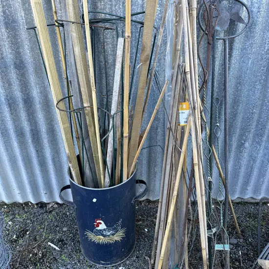 bin full of garden stakes etc