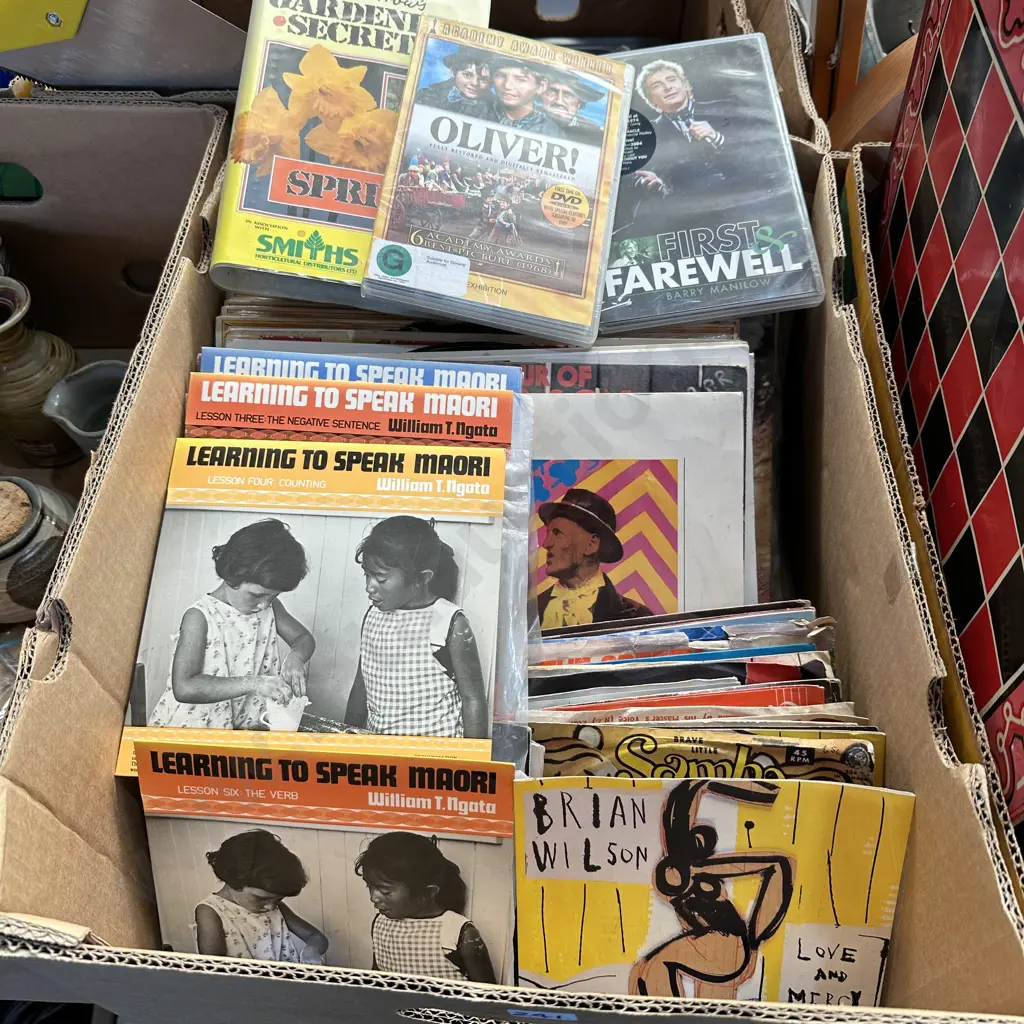 Box lot of DVDs and records including Learnin to speak Maori 45s. Image 1++