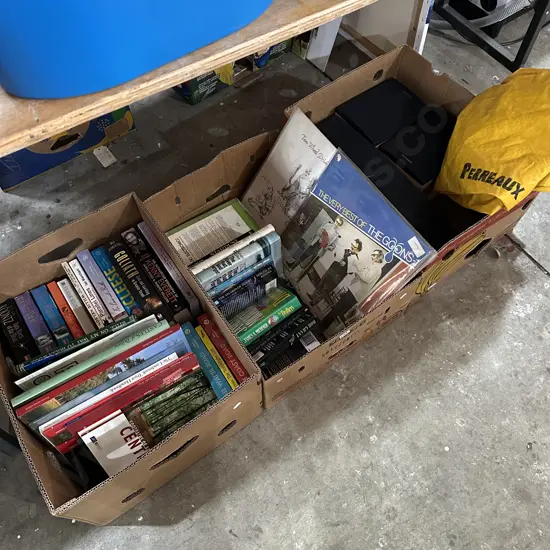 Three boxes books, speakers and wet weather leggings.