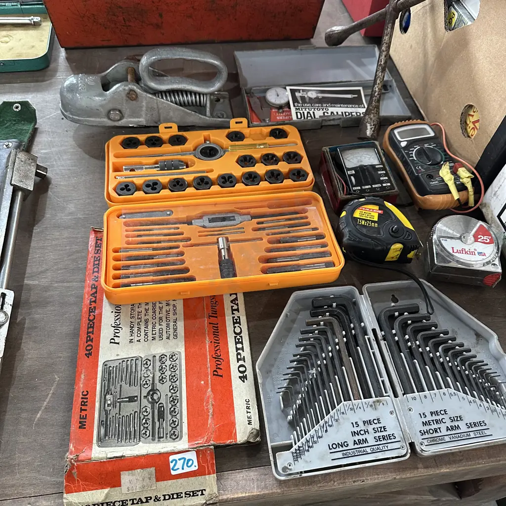 Tap and die set, trailer hitch, dial calipers, alan key set, tape measures and meters etc. Image 1++