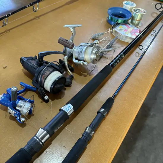 Shimano Surfcasting rod, Rogue rod, three reels, fishing line and sinkers.