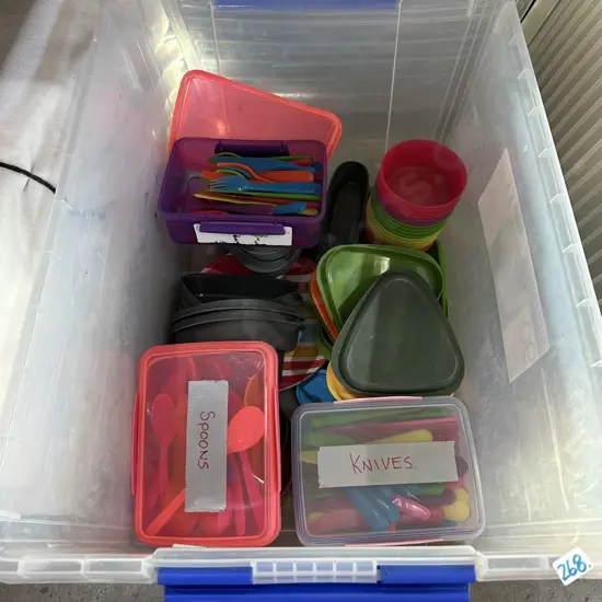 Bin of plasticware including cutlery etc.