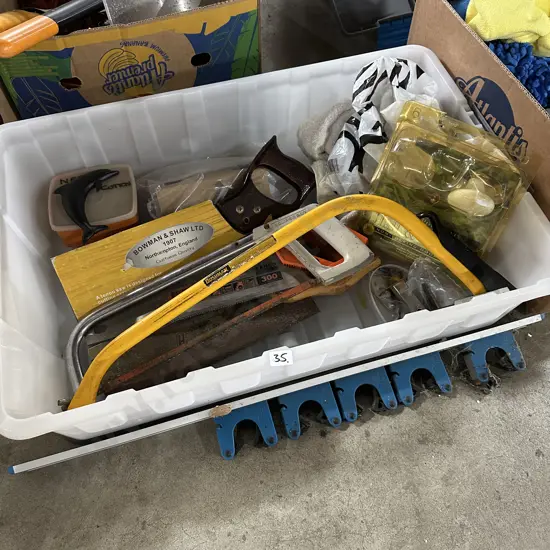 Lidded bin with assorted tools and hardware.