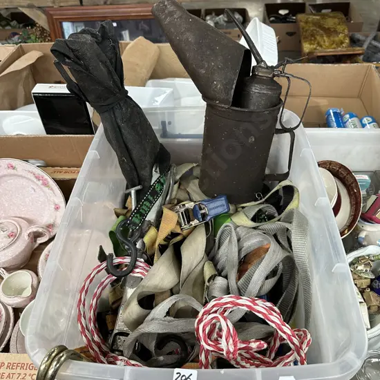 Bin of tie downs, scissor jack, oiler and oil filling can etc.