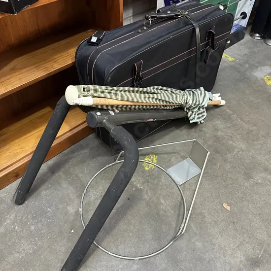 bike rack and damaged umbrella, basketball hoop and suitcase
