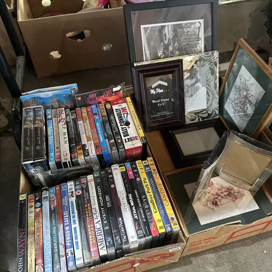 Two boxes DVDs and picture frames.