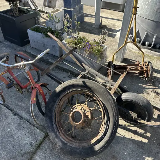 4 items garden art (hand mower, barrow frame, wheel, trike)