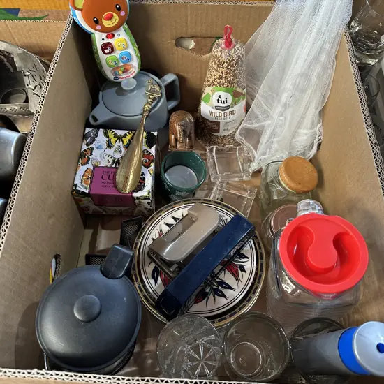 Box lot wild bird seed bell, food nets, toy puzzle and phone, vintage brass shoehorn etc.