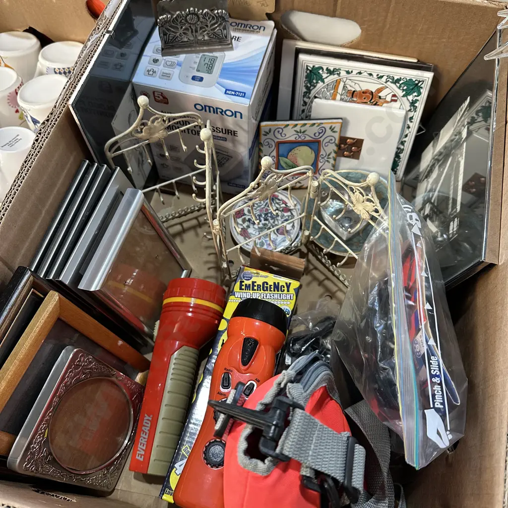 Box lot EMERGENCY wind-up flashlight/phone charger, good picture frames, blood pressure monitor etc. Image 1++