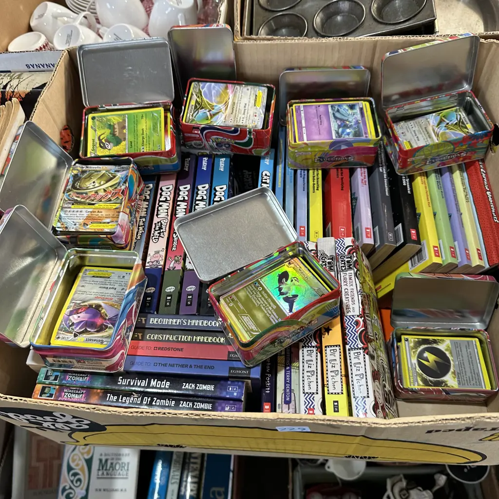 Box of childrens books and lots of Pokemon collector cards. Image 1++