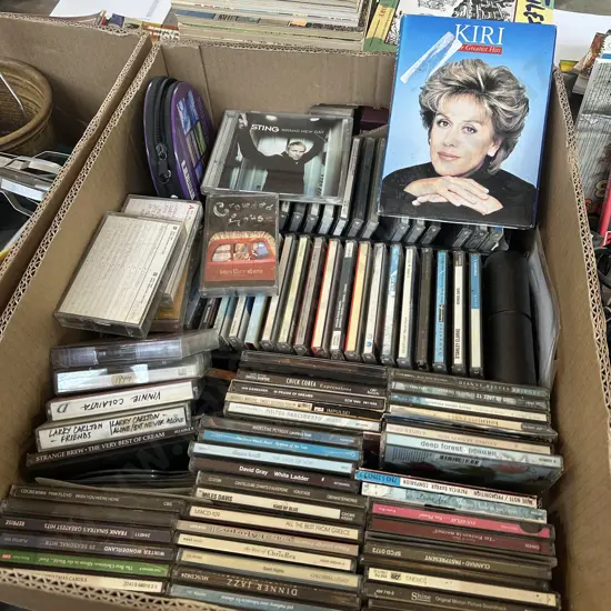 Box lot of assorted CDs and tapes.