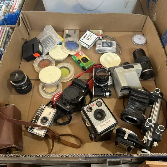 Box lot of assorted cameras and accessories.