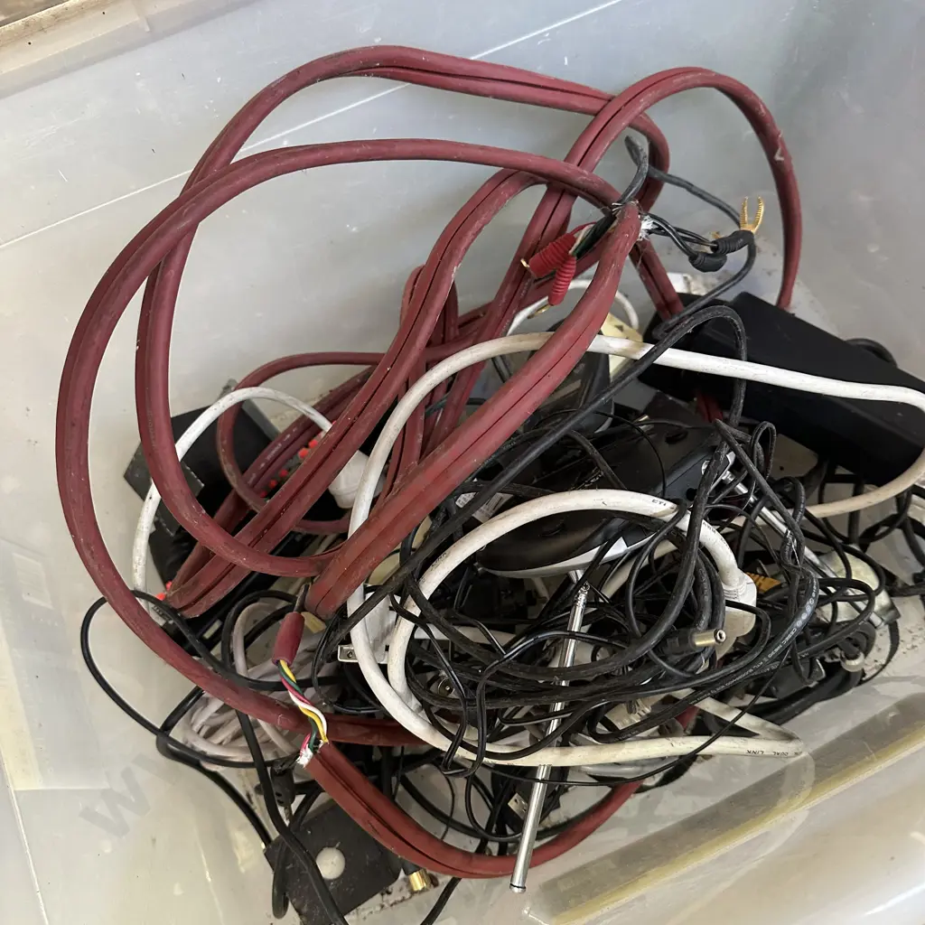 Lidded bin of electrical cables including speaker cables. Image 1++