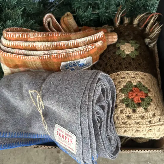 Two pure wool blankets and a handmade crochet blanket.