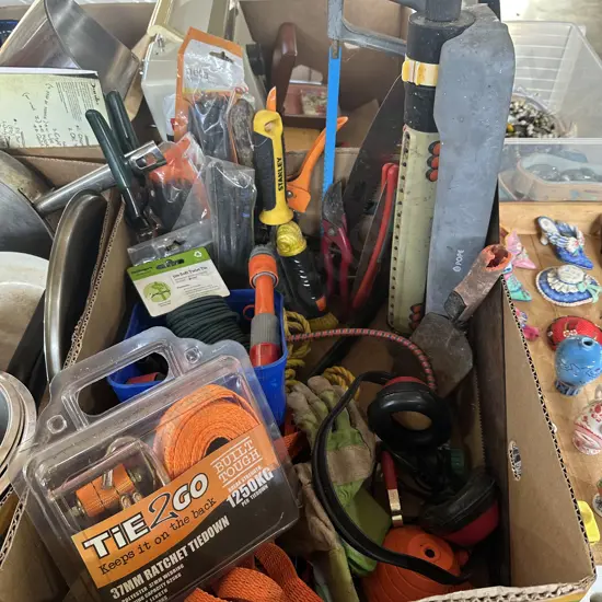 Box lot garden tools and saws, tie downs, sprinklers and hose attachments etc.